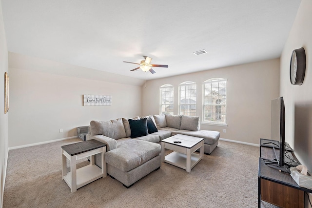 carpeted living room with ceiling fan