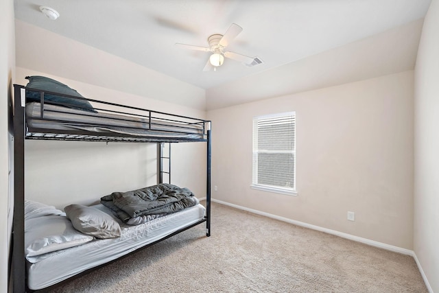 carpeted bedroom featuring lofted ceiling and ceiling fan