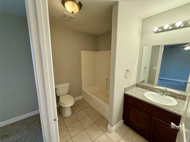 full bathroom with washtub / shower combination, tile patterned floors, toilet, and vanity