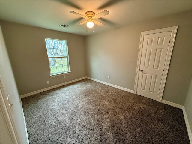 spare room featuring ceiling fan and carpet