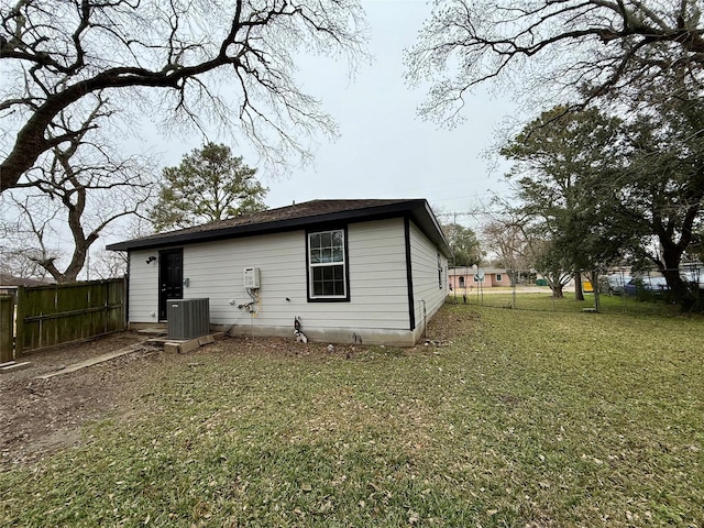 back of house featuring a yard and central air condition unit