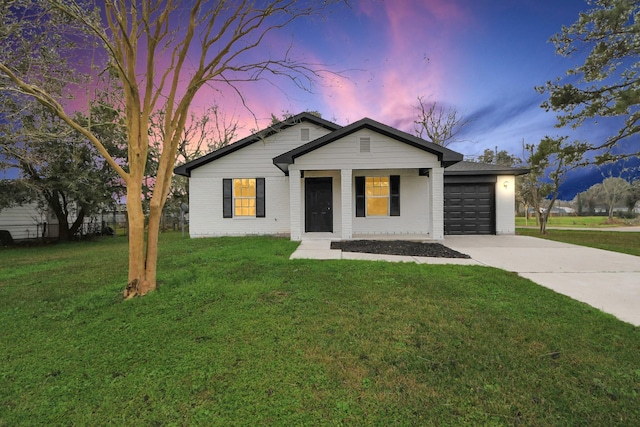 single story home featuring a garage and a lawn