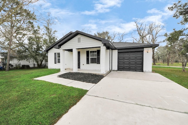 ranch-style home featuring a garage, a front yard, and covered porch