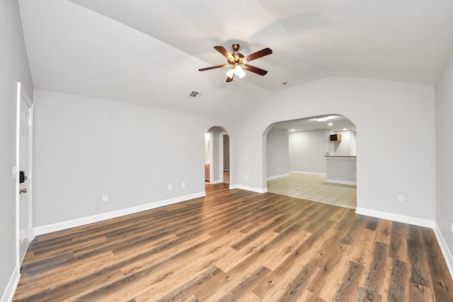 unfurnished living room with lofted ceiling, dark hardwood / wood-style floors, and ceiling fan