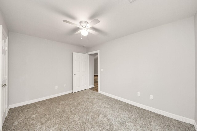 carpeted empty room with ceiling fan