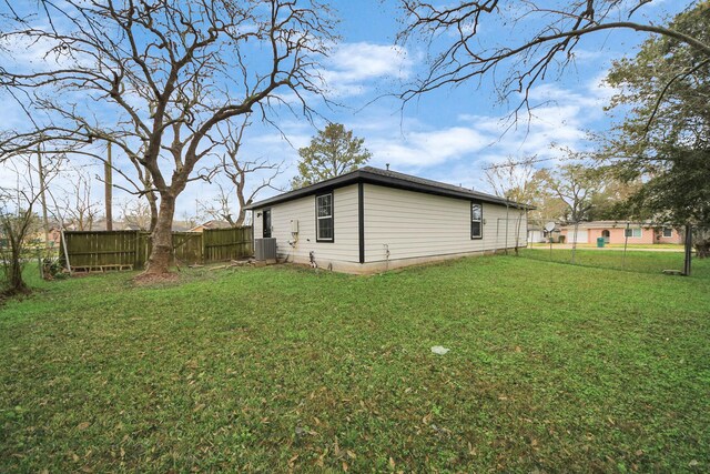 view of home's exterior featuring central AC and a yard