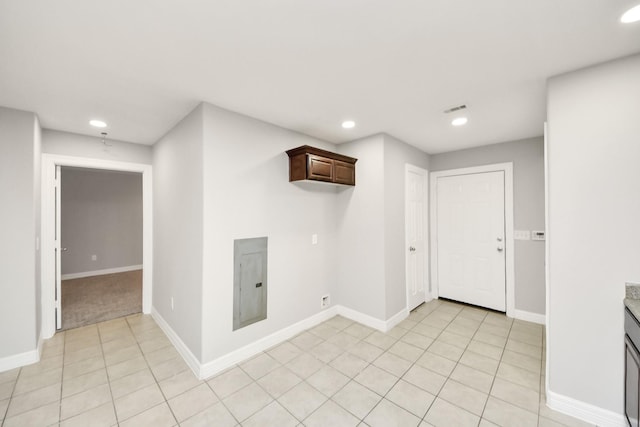 interior space featuring light tile patterned floors and electric panel