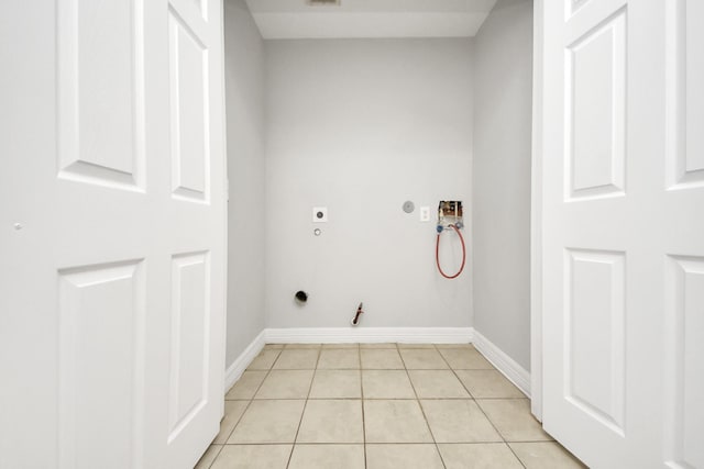 clothes washing area featuring hookup for a gas dryer, electric dryer hookup, hookup for a washing machine, and light tile patterned floors