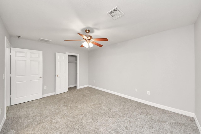 unfurnished bedroom featuring a closet, ceiling fan, and carpet flooring