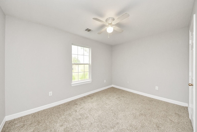 spare room featuring carpet flooring and ceiling fan