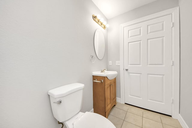 bathroom featuring vanity, toilet, and tile patterned flooring