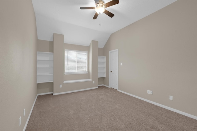 unfurnished bedroom featuring light carpet, vaulted ceiling, and ceiling fan