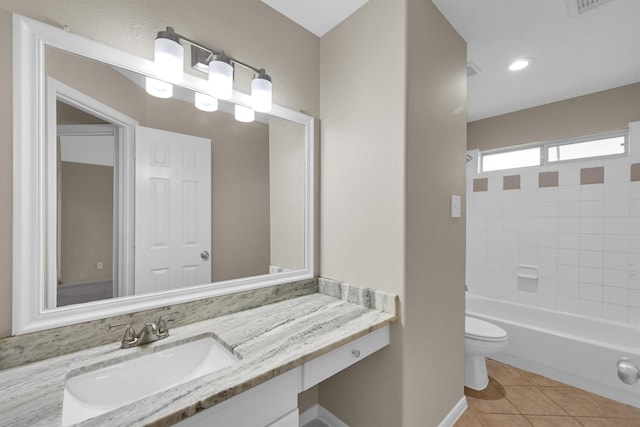 full bathroom with vanity, toilet, tiled shower / bath combo, and tile patterned flooring