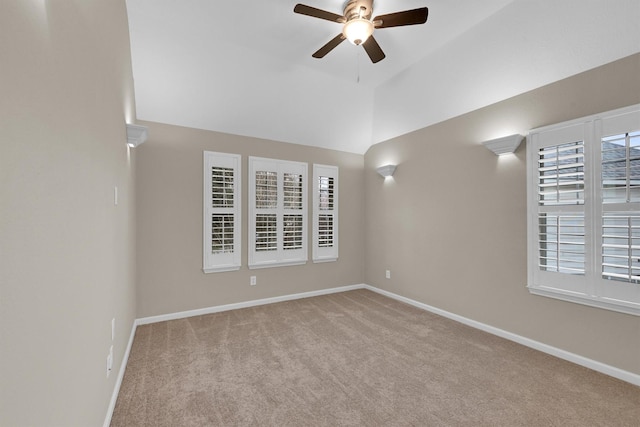 unfurnished room with vaulted ceiling, light carpet, and ceiling fan