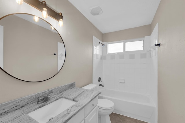 full bathroom with vanity, tiled shower / bath combo, tile patterned floors, and toilet