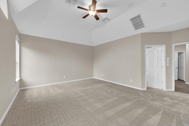 empty room featuring ceiling fan, lofted ceiling, and carpet flooring