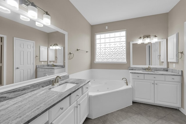 bathroom featuring vanity, tile patterned flooring, and a bathtub