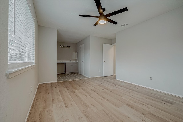 empty room with light hardwood / wood-style flooring and ceiling fan