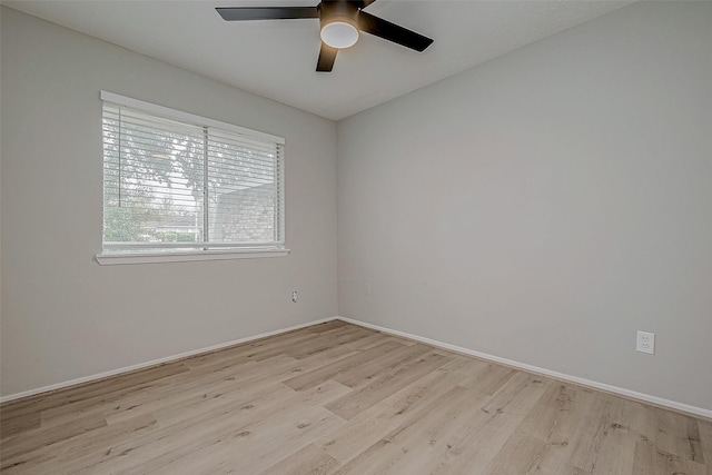 spare room featuring light hardwood / wood-style flooring and ceiling fan