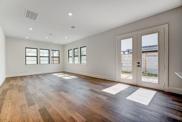 unfurnished room featuring french doors and hardwood / wood-style flooring