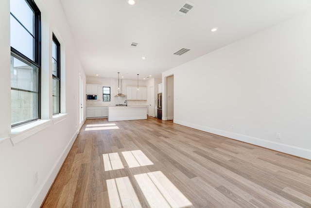 unfurnished living room with light wood-type flooring