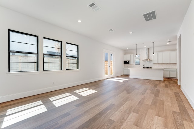 unfurnished living room featuring light hardwood / wood-style flooring