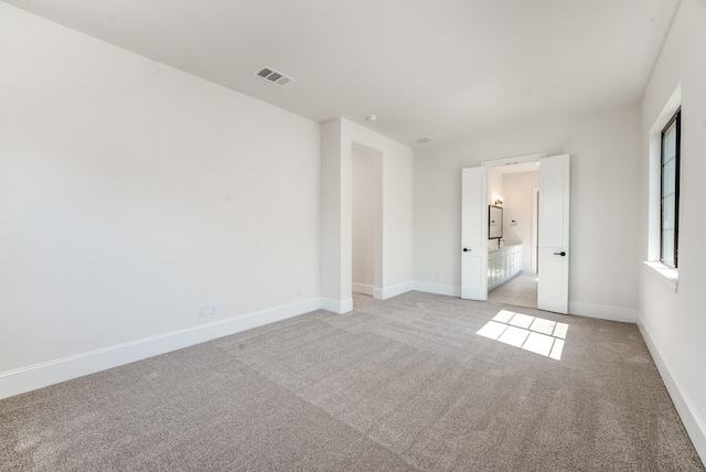 empty room featuring light colored carpet