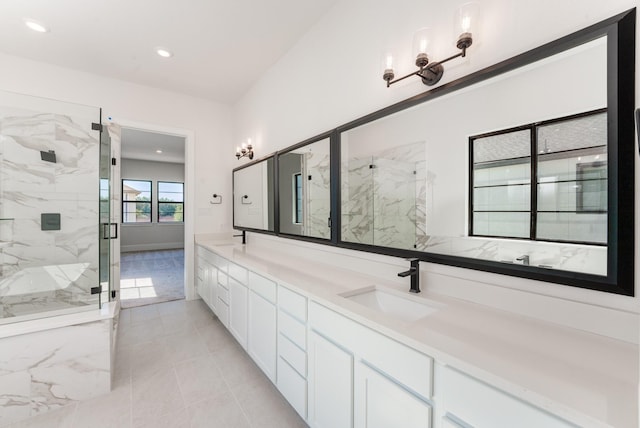 bathroom featuring vanity, a shower with shower door, and tile patterned floors