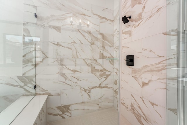 bathroom with a tile shower