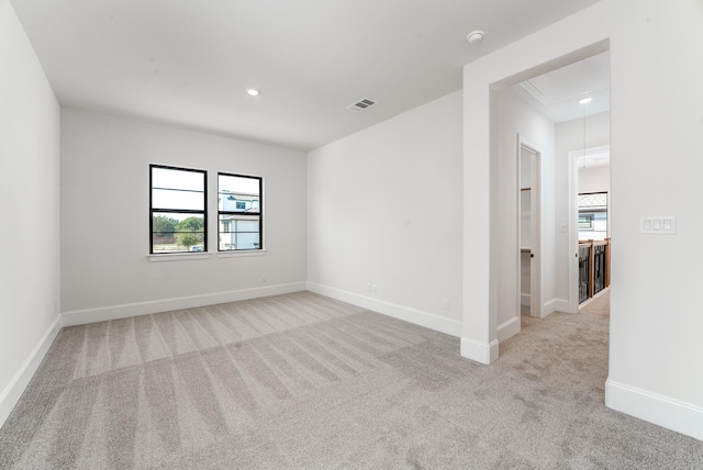 empty room featuring light colored carpet