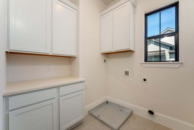 washroom featuring cabinets, light tile patterned floors, hookup for a washing machine, electric dryer hookup, and hookup for a gas dryer