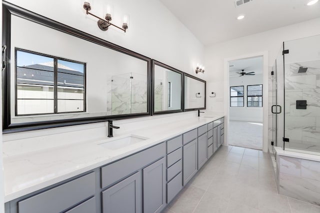 bathroom with an enclosed shower, vanity, plenty of natural light, and ceiling fan