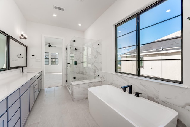 bathroom with vanity, tile walls, independent shower and bath, and ceiling fan