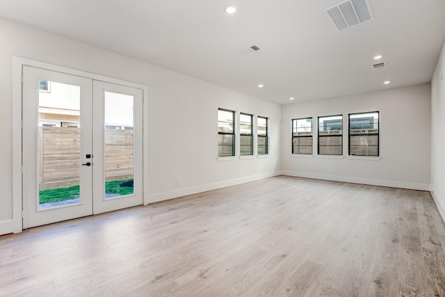 empty room featuring light hardwood / wood-style flooring and french doors