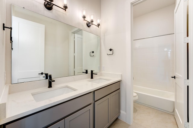 full bathroom featuring vanity, tile patterned floors, toilet, and washtub / shower combination