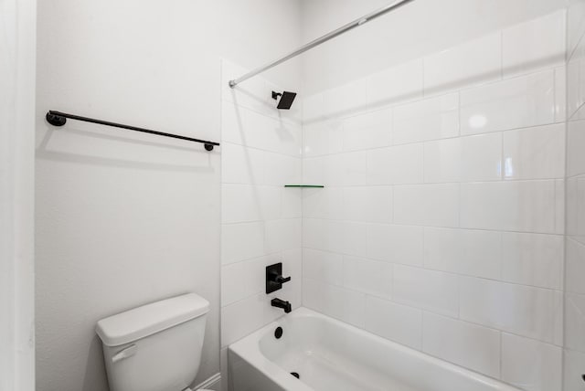 bathroom featuring tiled shower / bath and toilet