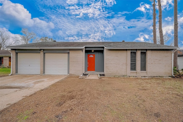 ranch-style home with a garage and a front lawn