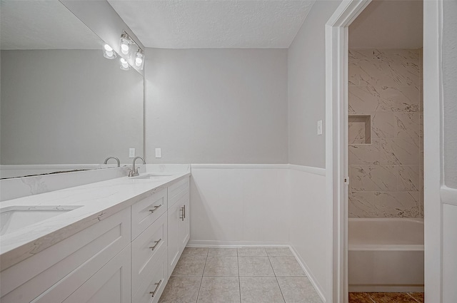 bathroom with vanity, tile patterned floors, and a textured ceiling