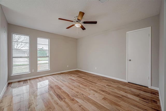 unfurnished room featuring ceiling fan, a textured ceiling, and light wood-type flooring