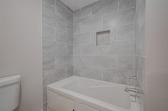 bathroom featuring shower / bathtub combination and toilet