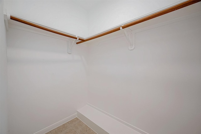 spacious closet with light tile patterned floors