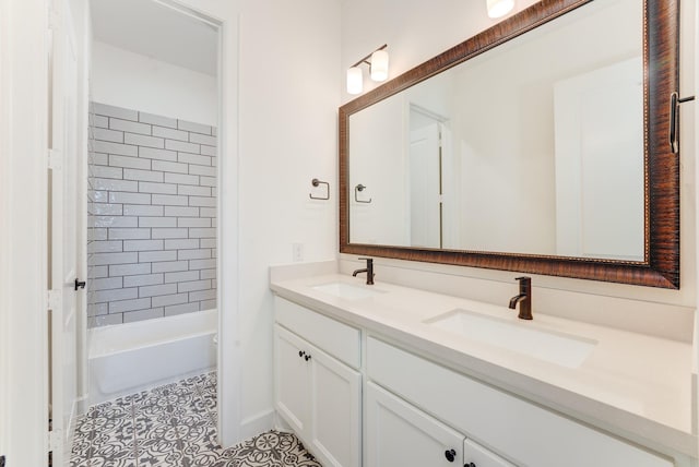 bathroom featuring tile patterned flooring, vanity, and tiled shower / bath