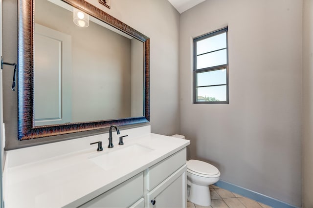 bathroom featuring vanity, tile patterned floors, and toilet