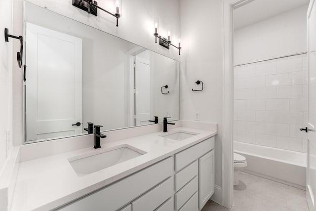 full bathroom with vanity, toilet, and tiled shower / bath combo