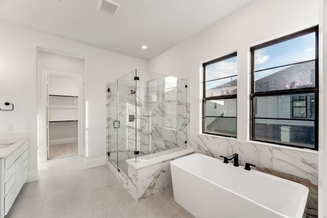 bathroom with vanity and separate shower and tub