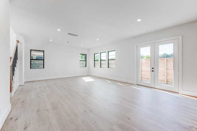 spare room with light hardwood / wood-style flooring and french doors