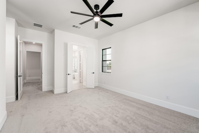 unfurnished bedroom with light colored carpet and ceiling fan