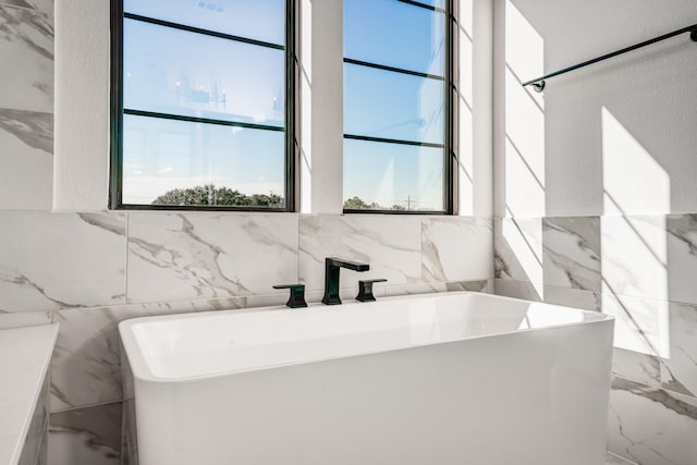 bathroom featuring a washtub and sink