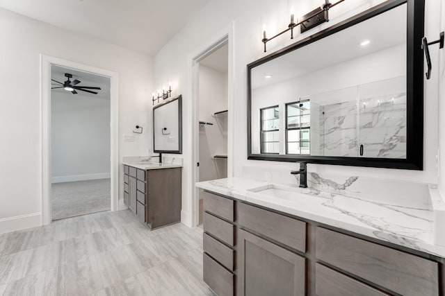 bathroom featuring vanity, ceiling fan, and walk in shower