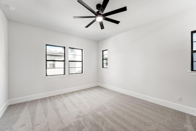 spare room with light colored carpet and ceiling fan